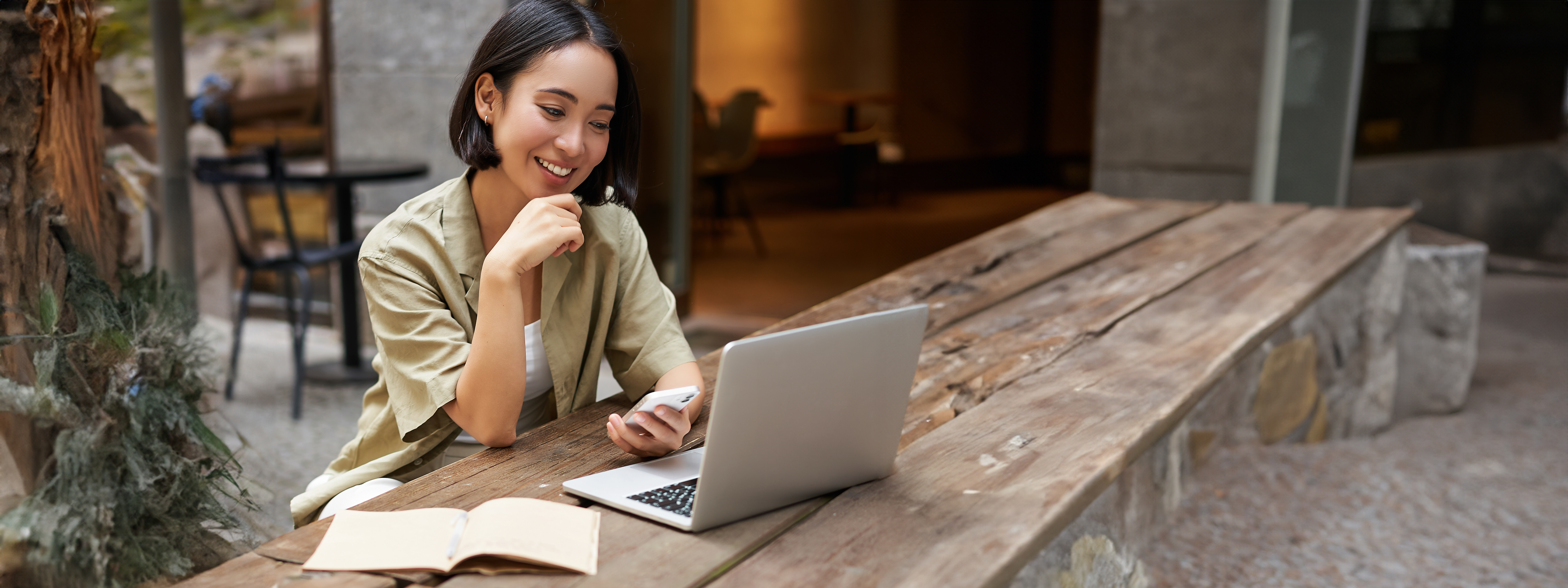 portrait-stylish-urban-woman-working-laptop-from-outdoor-cafe-sitting-with-documents.jpg